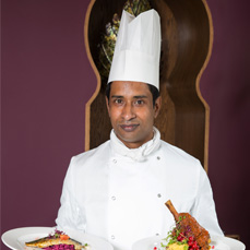 Chef Holding Two Main Dishes – Rose Indienne